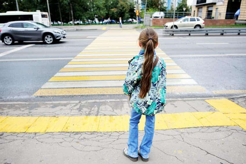 child crossing the road at a crosswalk