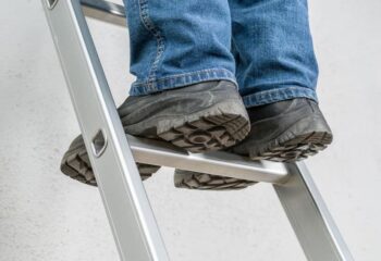 close up of a person standing on a ladder