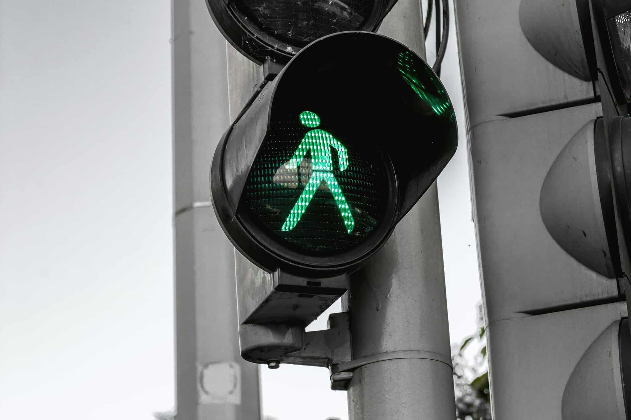 pedestrian walk symbol lit up in green